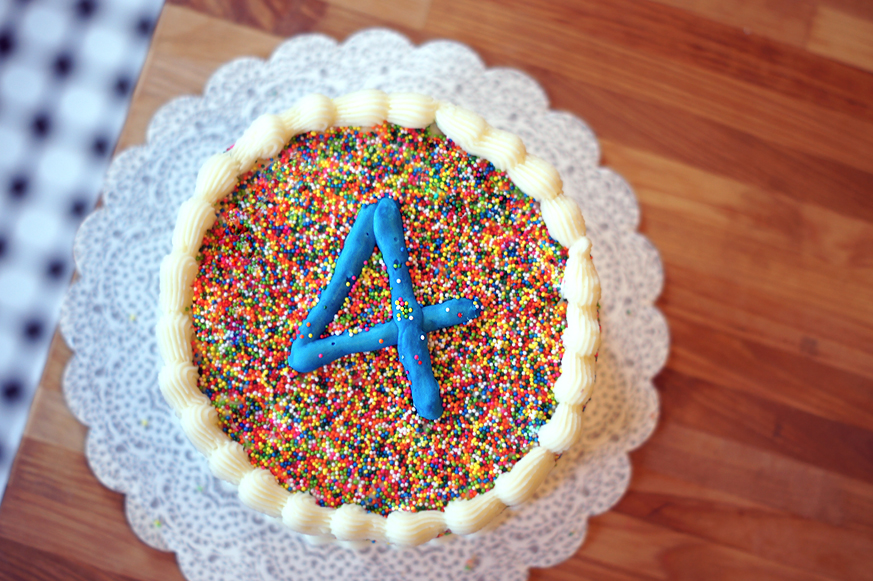 Sprinkle Covered Birthday Cake with homemade Funfetti cake inside! (Plus the secret to covering a cake in sprinkles without rolling the whole cake around!)