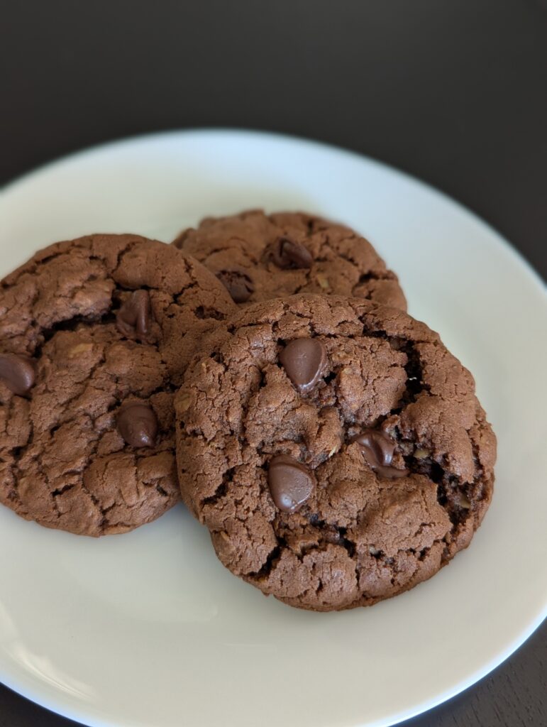 Chocolate brown cookies with a crinkled top dotted with chocolate chips.